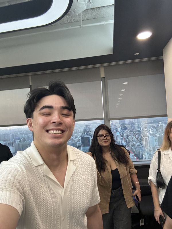 Julian Stafford smiling in the office with a city view behind him