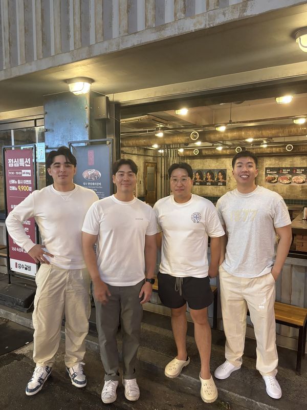 Julian Stafford (left) with the team outside a restaurant in Korea
